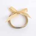 Set de pulseras jelly con purpurina dorada y un lazo decorativo de satén superior - Dorado
