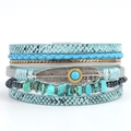 Detail view of bohemian multi-layer leather bracelet with turquoise and feather charms - Lake Blue
