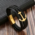 Detalle de pulsera de cuero negro trenzado de varias capas con ancla dorada y cierre imán - Negro (Ancla Dorada)