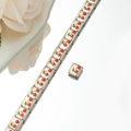 Detailed macro of Italian charm bracelet links featuring enameled red cherry motifs - Red Cherry Style (HA-7)