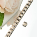 Close-up of an Italian charm bracelet with a black and white enamel bull charm and a rose - Zodiac Ox Style (HA-16)