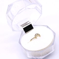 Golden moon-shaped nose ring with five small clear zircon stones on white foam background - Moon / Steel