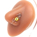 Macro shot of silver wire-wrapped nose ring clip with yellow evil eye on silicone model - Platinum Yellow Eye