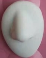 White silicone nose model for medical teaching and piercing practice on pink background - Nose Model / White