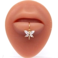 Golden butterfly lip ring with white zircon wings displayed on a silicone lip model - Gold Dragonfly Style (#3)