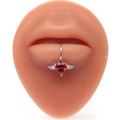Detail of silver lip ring with red heart gemstone and wings on a silicone model - Silver Red Winged Heart Style (#12)
