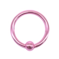 Macro detail of a matte pink stainless steel horseshoe ring piercing with a ball closure - Pink