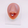 Detail of silver heart-shaped septum ring with lavender opal on silicone nose model - Purple Iridescent Heart Septum Ring