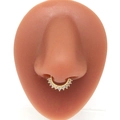 Detail view of a gold-plated nose ring with pink zircons on a silicone model - Gold Pink Zirconia Style (#5)
