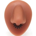 Matte black stainless steel faux septum ring with vintage tribal sun pattern on a nose model - Black Tribal Sun Pattern Style (#11)