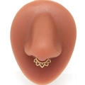 Detail of a gold lotus septum ring with dot accents on a silicone nose model display - Gold Hollow Lotus Style (#8)