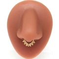 Detailed view of a golden skull-style faux septum ring displayed on a nose model - Gold V-Shape Beaded Style (#7)