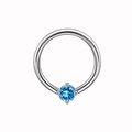 Macro detail of silver piercing hoop with a four-prong set round blue gemstone inlay - Blue Rhinestone Style (NPR3112362)
