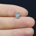 Detailed close-up of a crescent moon nose stud featuring turquoise stones in silver metal - Turquoise Moon Style (24080304050)
