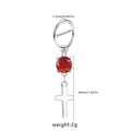 Macro detail of stainless steel nose ring with red gemstone and cross pendant charm - Red Zirconia Cross Style (NR24103101-6)