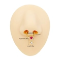 Golden heart arrow septum ring with red gemstone and clear zircon on a nose model - Gold Heart Arrow Style (NR25031901-6)