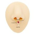 Gold-tone stainless steel heart and arrow septum ring with a red stone on a nose model - Gold Heart Arrow Dangle Style (NR25031901-7)