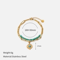 Detail of gold stainless steel layered bracelet with turquoise beads and sunburst pendant - Long Link Chain With Turquoise Beads Sun Disc Style (CH1331)