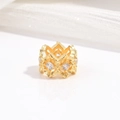 Macro detail of gold crown ring with hollow design and inlaid cubic zirconia stones - Zirconia Rhombus Bead / Gold