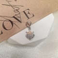 Macro shot of silver S925 heart pendant with crown detail and pavé cubic zirconia - Style C