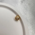 Golden S925 silver cylinder bead with pave cubic zirconia on a white tray - Gold