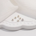 Macro view of 6 pieces S925 sterling silver crimp bead covers for DIY jewelry making - Silver Small