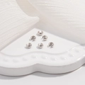 Macro shot of silver S925 sterling silver crimp bead covers on a white ceramic plate - White K Small Size