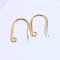 Detail shot of pair of polished gold-finished U-shape earring hooks with ring connectors - Gold