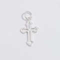 Detailed close-up of a hollow silver cross pendant with vintage curved edge decorations - Cross / Silver