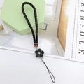 Detailed view of woven black leather phone lanyard with camellia flower and rhinestone charm - Woven Rope Small Flower Black (K6153)