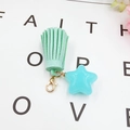 Detail of mint green tassel and sky blue star charm with gold lobster clasp - Green with Blue Star