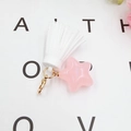 Close-up of pink star charm with white faux leather tassel on a golden lobster clasp - Star Tassel Charm (K1452) / White with Pink Star
