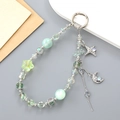 Crystal star and moon beaded phone charm in mint green with iridescent accents - Green