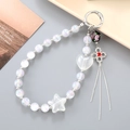 Beaded phone strap featuring white iridescent beads, heart charms, and black flower tassel - White Star Charm (K4949)