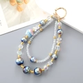 Blue star pattern beaded phone strap with gold spring ring clasp and pearl bow charms - Blue (K4655)