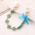 Handmade woven phone strap with blue ribbon bow and square sea blue crystals on gold chain - Rhinestone Ribbon Bow Hand Chain Blue