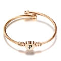 Detail van roségouden gevlochten kabelarmband met hartvormige hanger en letter P gegraveerd - Initiaal P