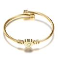 Golden twisted cable bracelet with a heart pendant featuring an engraved letter G - Rose Gold