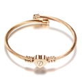 Roségouden gevlochten kabelarmband met een hartje en gegraveerde letter D - Roségoud