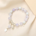Close-up of beaded crystal bracelet with silver cat, star and bell lucky charms - Purple (K3399)