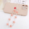 Detailed macro view of pink acrylic frosted flower beads on a sweet style phone lanyard - Orange