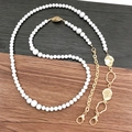 Elegante Handy-Umhängekette aus weißen Perlen und goldfarbenem Metall mit Karabiner - Gold