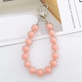 Detailed macro view of pastel beaded ring charm with silver metal lobster clasp and swivel ring - Bead-in-Bead Pendant / Orange