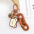 Détail du porte-clés toast dessin animé marron avec chaîne en résine et petite cloche - Chaîne Marron Pain Grillé