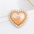 Elegant pearl-rimmed heart charm with pink pearlescent finish on a gold base - Iridescent Orange (D1232)