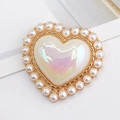 Macro detail of heart-shaped pearl charm with iridescent gemstone in gold frame - Iridescent White (D1238)