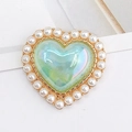 Detail of heart-shaped charm with iridescent green center, pearls, and gold base - Iridescent Blue (D1237)