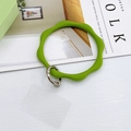 Detail view of a grass green wavy silicone wristband keychain with silver spring ring clasp - Green
