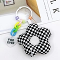 Checkerboard pattern flower plush keychain with colorful beads and heart tag on white background - Black and White