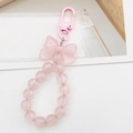 Pink beaded bow keychain with iridescent pearls and metal hook for phones and bags - Pink